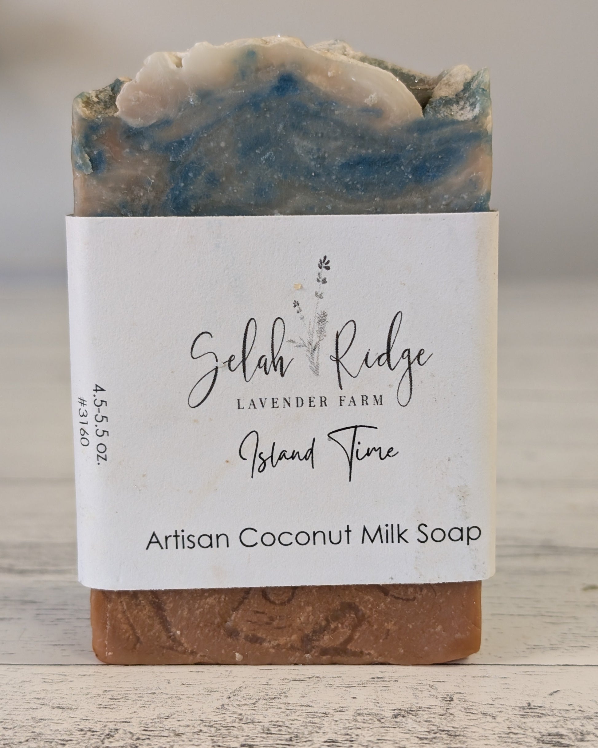 Artisan coconut milk soap with a label on a wooden surface