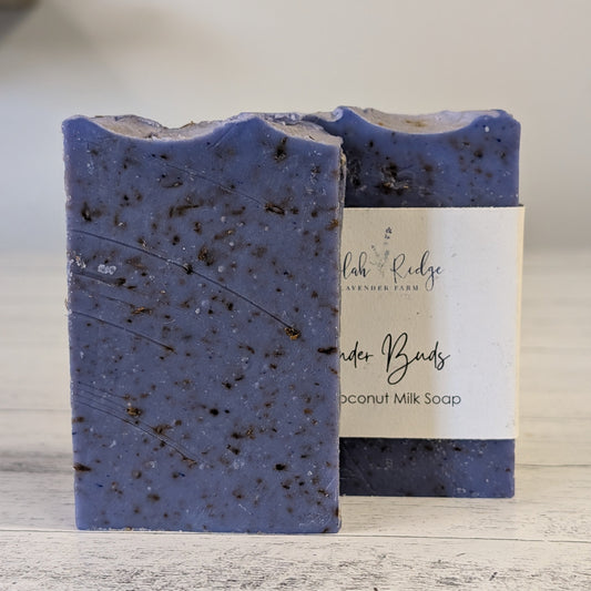 Blue speckled soap bar with a label on a wooden surface