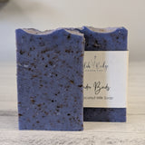 Blue speckled soap bar with a label on a wooden surface