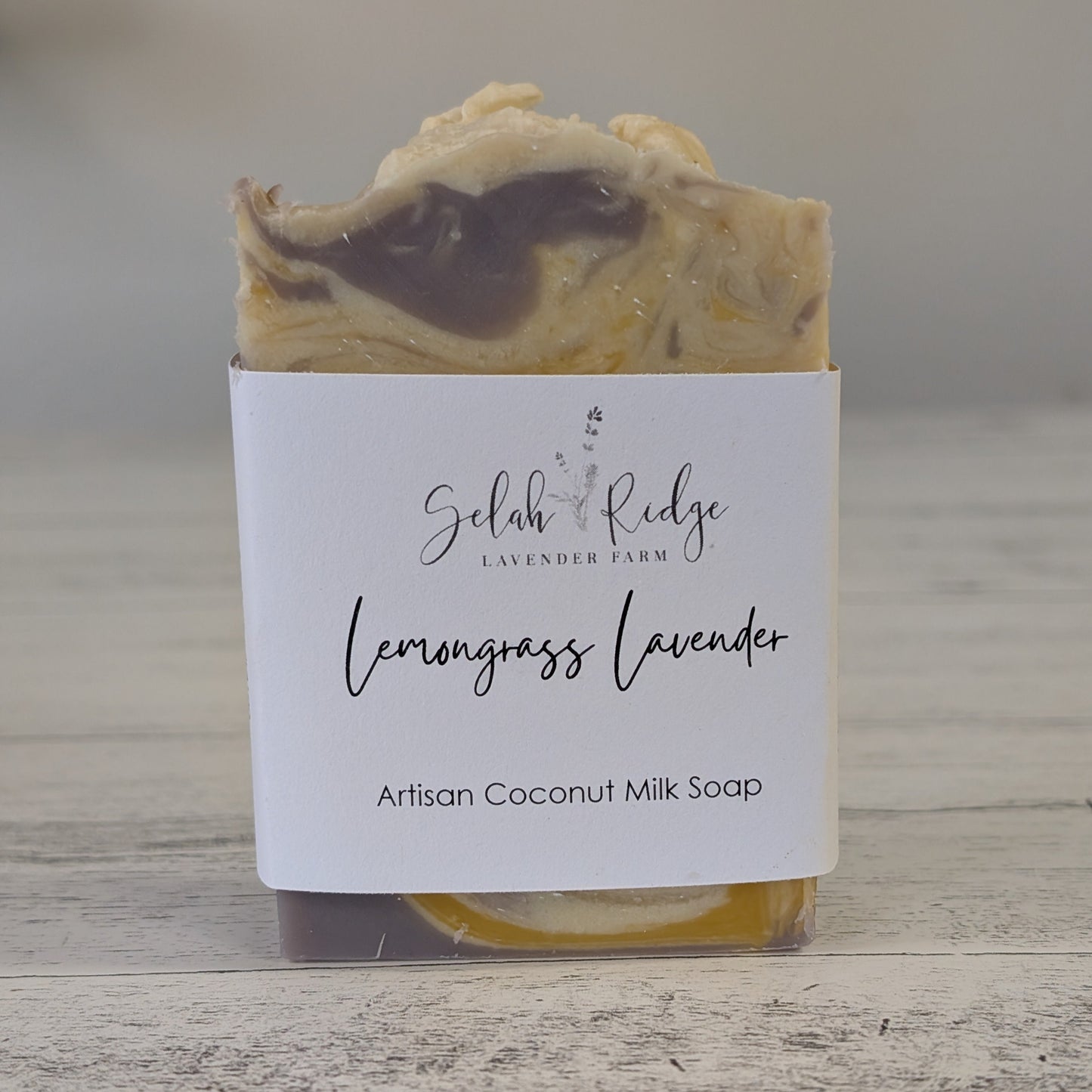 Artisan coconut milk soap with a label on a wooden surface